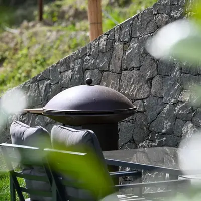 a grill sitting on a table next to a stone wall at Pitzoler Hof in Albes