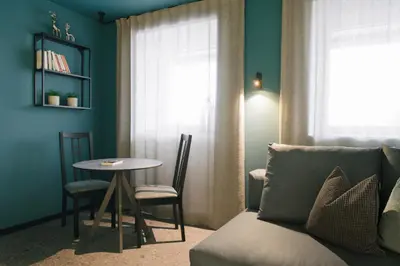 a living room with a couch and a table at Cityview Brixen in Bressanone
