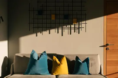 four pillows sitting on a couch in a living room at Cityview Brixen in Bressanone