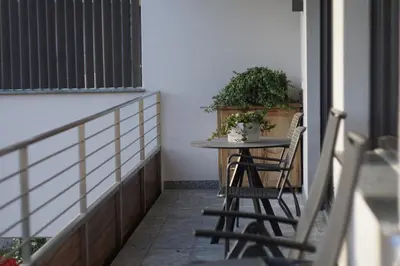 a small table and chairs on a balcony at Cityview Brixen in Bressanone