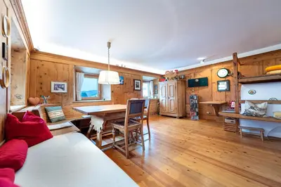 a living room with a table and a dining room at Apartments Frea - Vedl Luech da Plajes in Ortisei