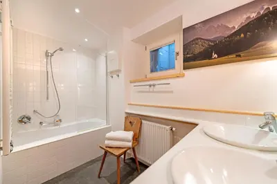 a bathroom with a sink and a tub and a shower at Apartments Frea - Vedl Luech da Plajes in Ortisei