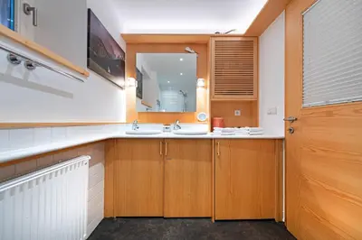 a bathroom with a sink and a mirror at Apartments Frea - Vedl Luech da Plajes in Ortisei