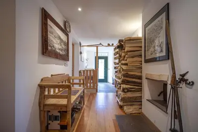 a living room with a stack of logs at Apartments Frea - Vedl Luech da Plajes in Ortisei