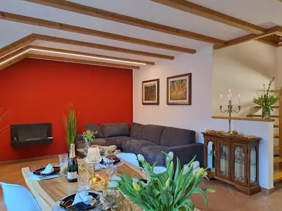 a dining room with a wooden table and chairs at Penthouse&Wellness L'Abete in Gargazzone