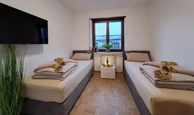 a bedroom with a bed with a gold scarf on it at Penthouse&Wellness L'Abete in Gargazzone