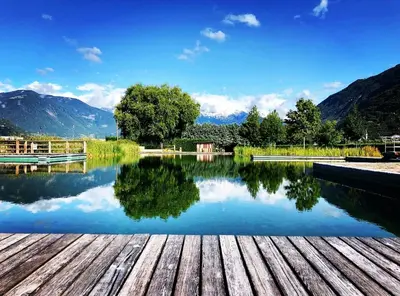 a view of a lake with mountains in the background at Penthouse&Wellness L'Abete in Gargazzone