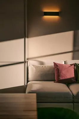 a couch with two pillows on it in a room at The Nest – 85 qm apartment - Mountain, Ski, Relax in Vila di Sopra