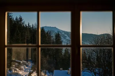 a window with a view of a snowy mountain at The Nest – 85 qm apartment - Mountain, Ski, Relax in Vila di Sopra