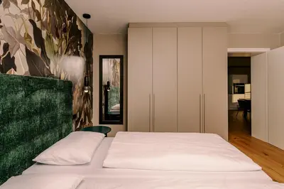 a bedroom with a bed and a painting on the wall at The Nest – 85 qm apartment - Mountain, Ski, Relax in Vila di Sopra