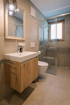 a bathroom with a sink and a toilet and a shower at The Nest – 85 qm apartment - Mountain, Ski, Relax in Vila di Sopra