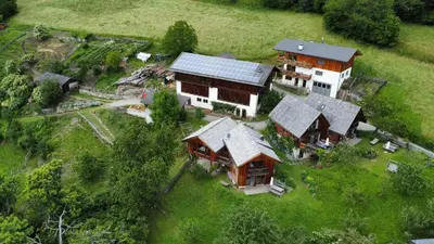 an aerial view of a house with a solar roof at Unterplattnerhof in Chiusa