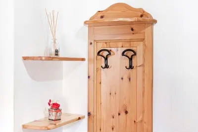 a wooden door in a room with a shelf at ciasa monaco in Corvara in Badia