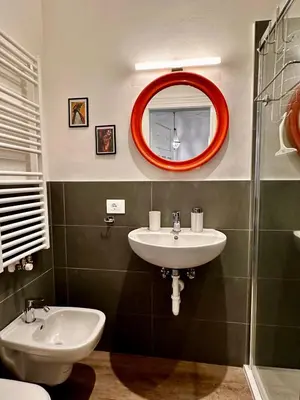 a bathroom with a sink and a mirror at Baker House in Bolzano