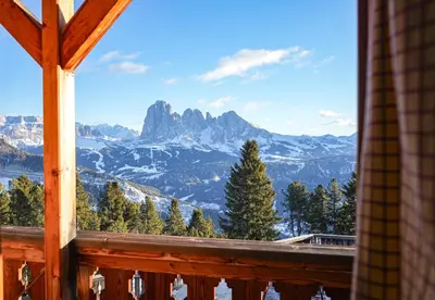a view of the mountains from a cabin window at Chalet Resciesa Ortisei in Ortisei
