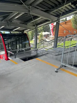 a platform at a train station with a train at Chalet Resciesa Ortisei in Ortisei
