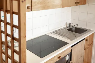 a kitchen with a sink and a counter at Casa Canazei in Canazei