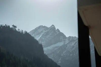 a view of a snow covered mountain from a window at Casa Canazei in Canazei