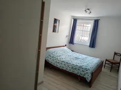 a small bedroom with a bed and a window at Ciasa del Faure in Pozza di Fassa