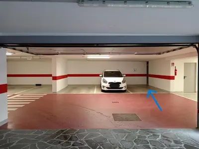 a car parked in a garage with a car in it at Ciasa del Faure in Pozza di Fassa