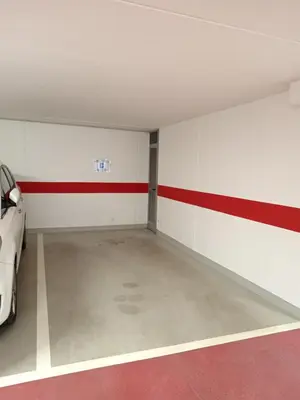 an empty garage with a car parked in it at Ciasa del Faure in Pozza di Fassa