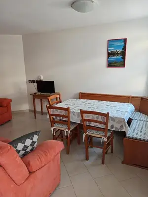 a living room with a table and chairs and a couch at Ciasa del Faure in Pozza di Fassa