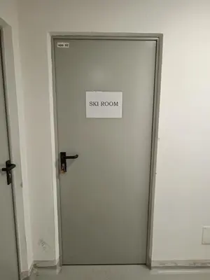 a sign on a door that says six room at Ciasa del Faure in Pozza di Fassa