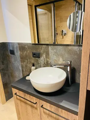 a bathroom with a white sink on a counter at Nuovo e comodo in Val di Fassa in Campitello