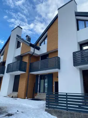 a building with balconies on the side of it at Nuovo e comodo in Val di Fassa in Campitello