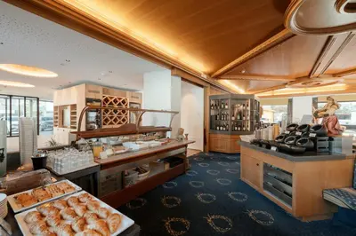 a bakery with a lot of food on display at Hotel Cristallo in Santa Cristina in Val Gardena