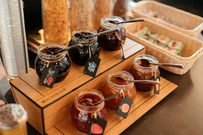 a wooden tray with jars of honey on a table at Hotel Cristallo in Santa Cristina in Val Gardena