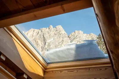 a window with a view of a mountain at CORTINA Lodge in Cortina dʼAmpezzo