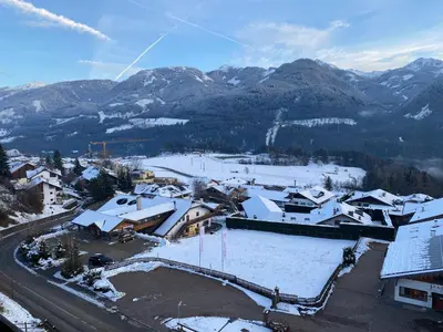 an aerial view of a town with snow covered roofs at Affittacamere Garden Cavalese in Cavalese