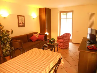a living room with a couch and a table at Residence Villa Avisio in Canazei