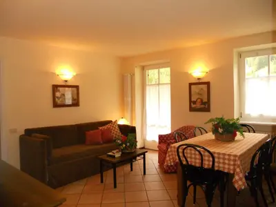 a living room with a couch and a table at Residence Villa Avisio in Canazei