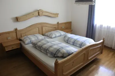 a bed with two pillows on it in a room at Feldlechn in Lappago
