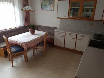 a kitchen with a table and a table and chairs at Feldlechn in Lappago