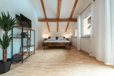 a bedroom with a bed and a large window at Felda Appartements in Lappago