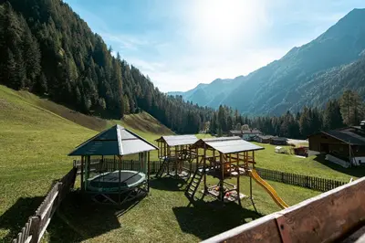 a group of gazebos in a field with mountains at Felda Appartements in Lappago