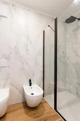 a white bathroom with a sink and a shower at Dolomiti Haus - Immerso nelle Dolomiti in Tesero