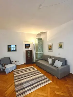 a living room with a couch and a fireplace at Townhouse Bozen in Bolzano