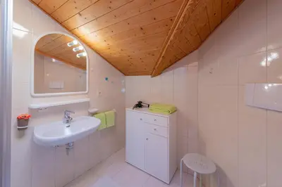 a bathroom with a sink and a mirror at Gfillhof Ferienwohnung 2 in Appiano sulla Strada del Vino