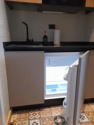 a refrigerator with its door open in a kitchen at Fradusta 213 in San Martino di Castrozza