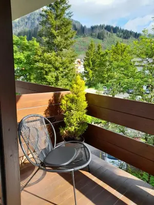 a chair sitting on a balcony with a view at Fradusta 213 in San Martino di Castrozza