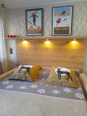 a bed with two pillows on top of it at Fradusta 213 in San Martino di Castrozza