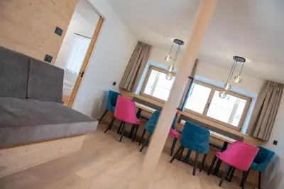 a bedroom with a table and chairs in a room at Apartments Corcela in San Vigilio Di Marebbe