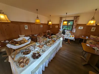 a long table with food on it in a room at Hotel Eden Guesthouse in Marlengo