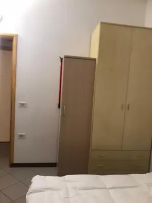 two wooden cabinets in a room with a bed at Bilocale Cristina Mazzin in Campestrin