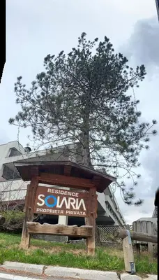 a sign with a tree in the background at Bilocale Cristina Mazzin in Campestrin