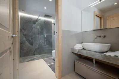 a bathroom with a glass shower and a sink at Casa Paolina - Alpine Stay Apartments in Tesero